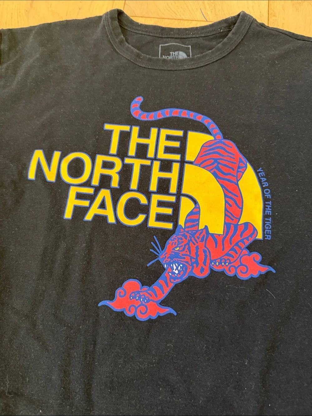 The North Face Black Tee with Yellow & Purple Graphic